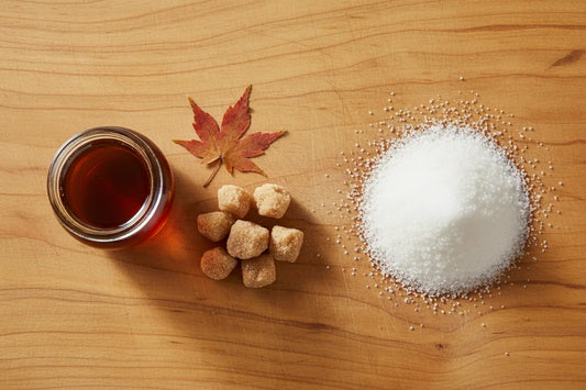 maple syrup sugar vs white sugar on a table