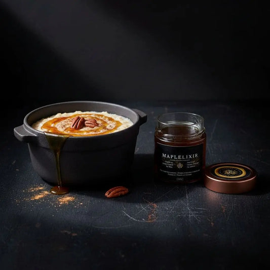 oatmeal in a pot , topped with maple syrup , some dusted brown sugar and a jar of maplelixir on the side